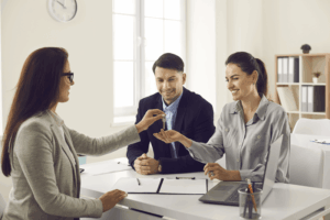 Handing keys to clients during closing day